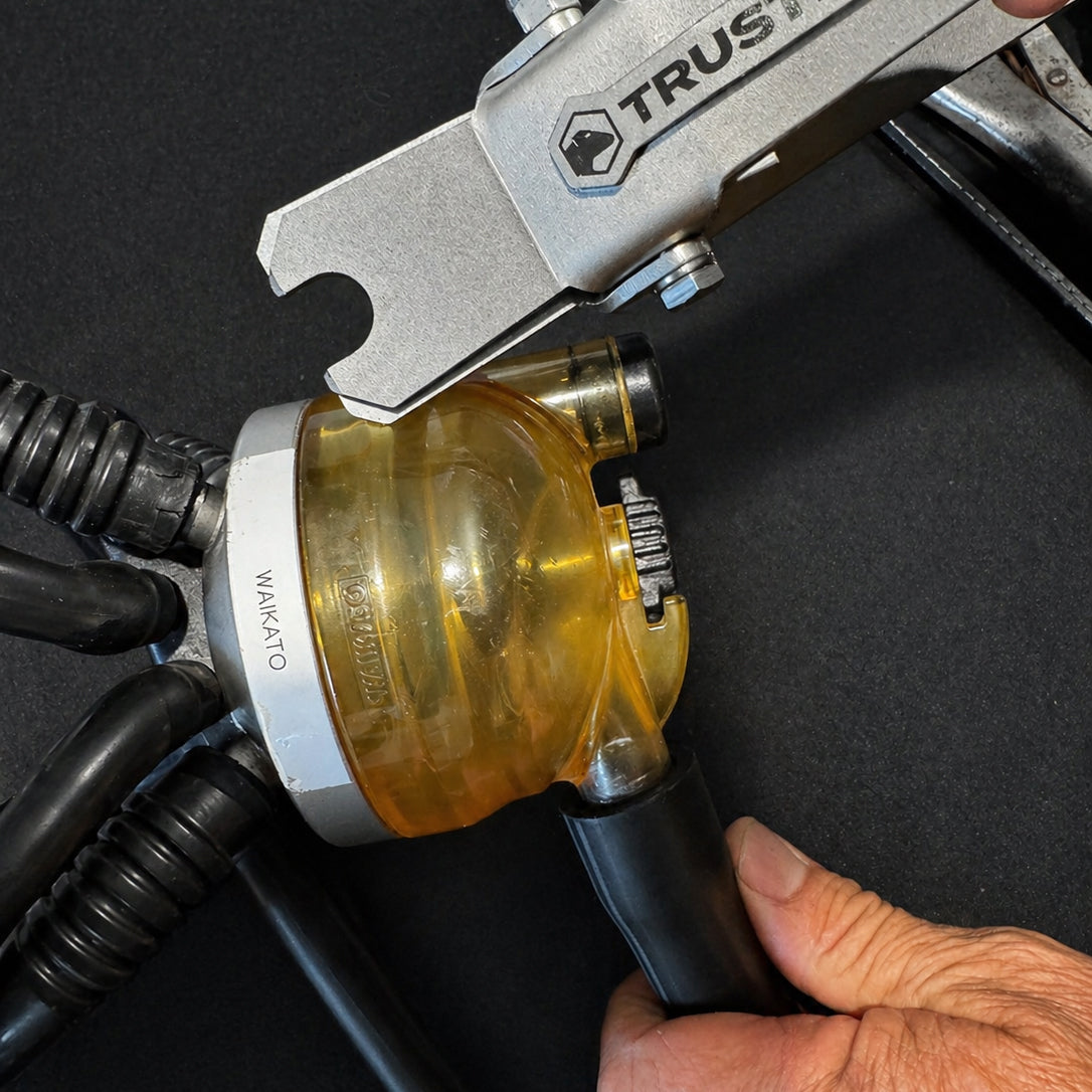 Close-up of a tool with 'TRUSTEN' branding on a black background